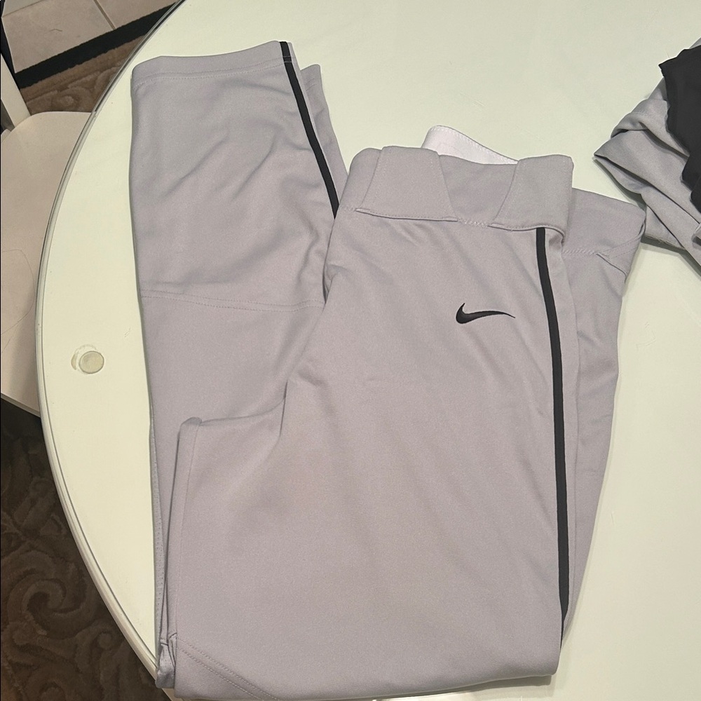 Mens Nike grey with black piping baseball pants size medium.
